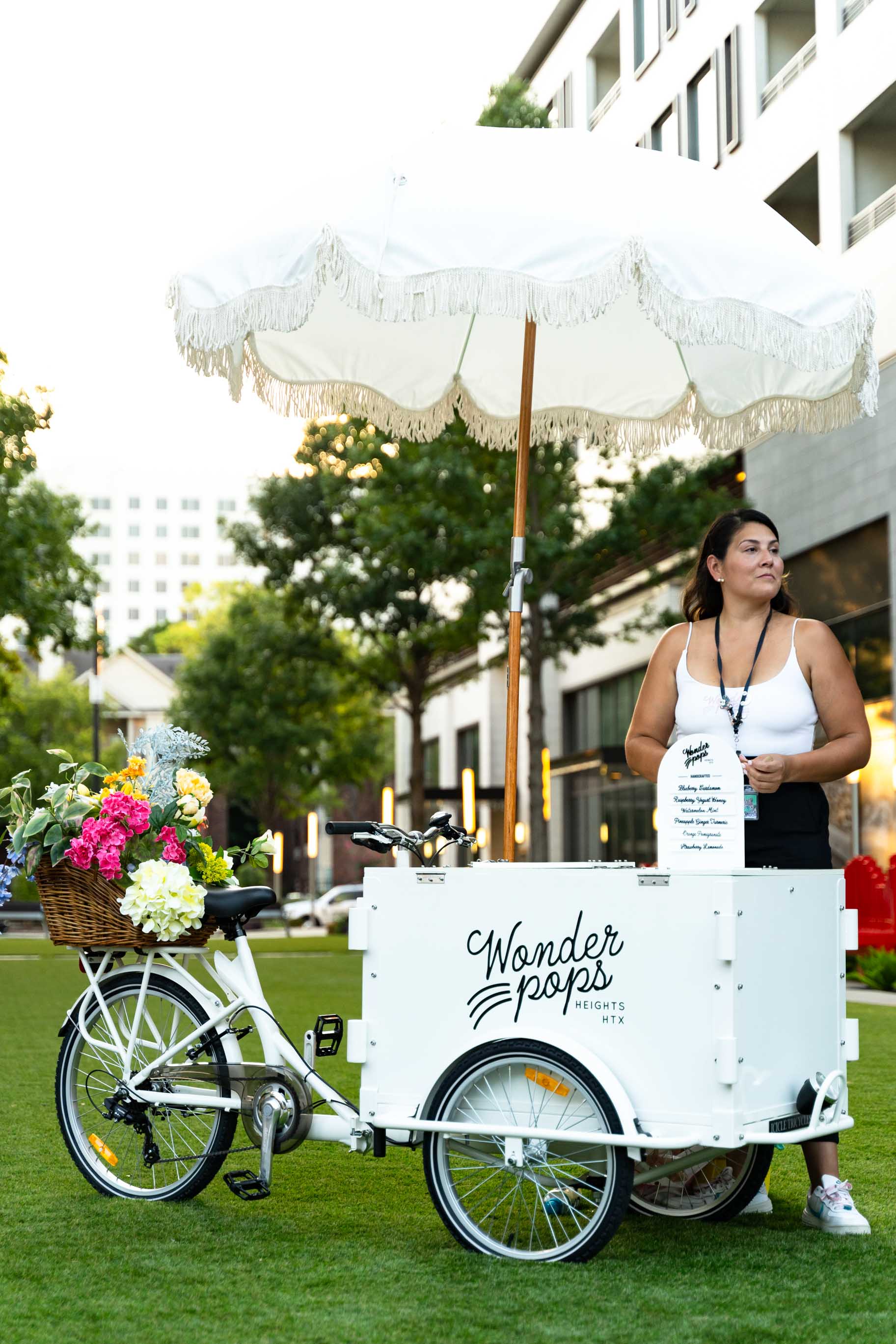 Fruit popsicles catering with server, white cart and umbrella. 