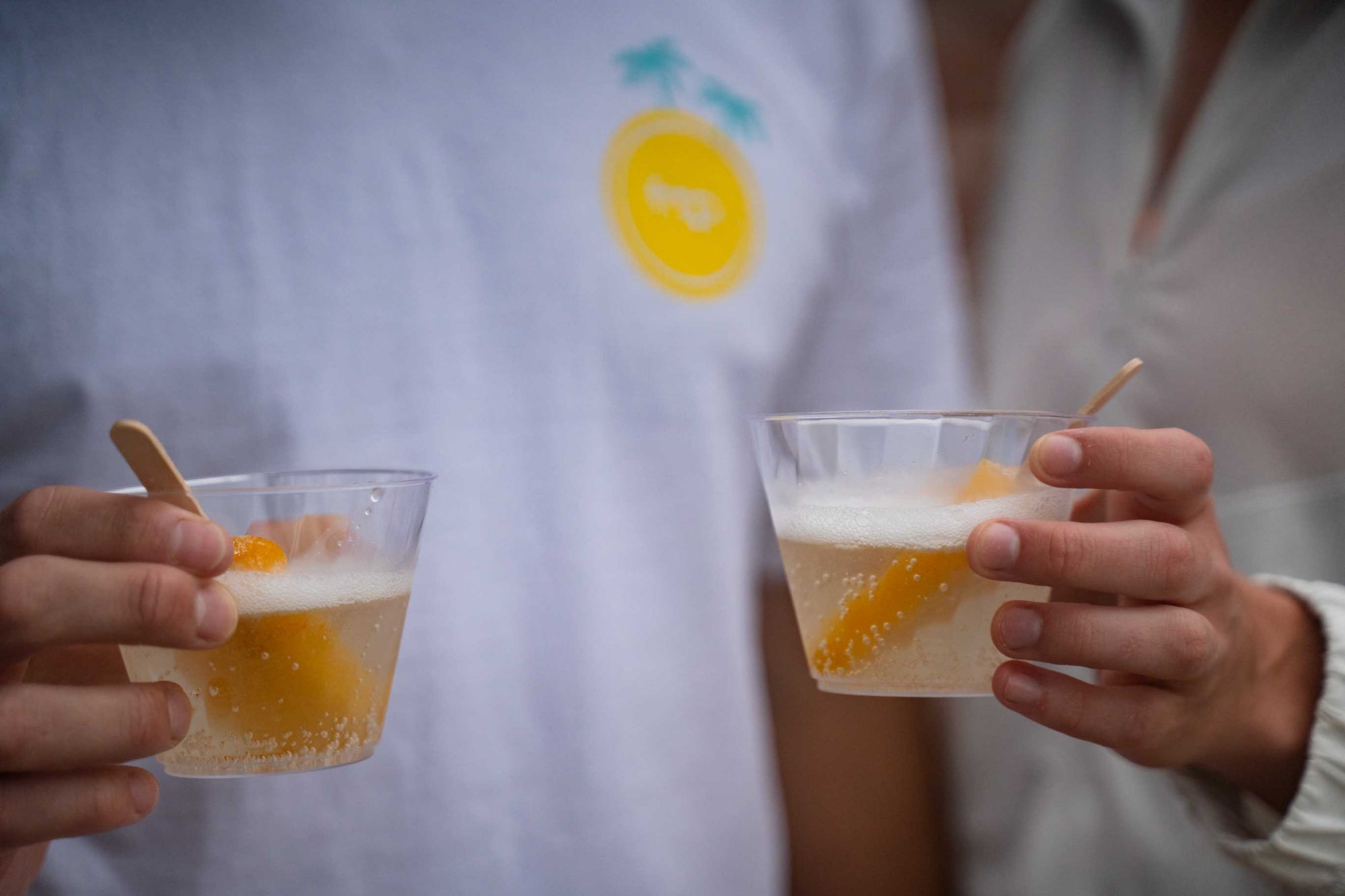 Woman and man holding a glass of white wine with a Specialty Ice Pop at a corporate event catering in Houston