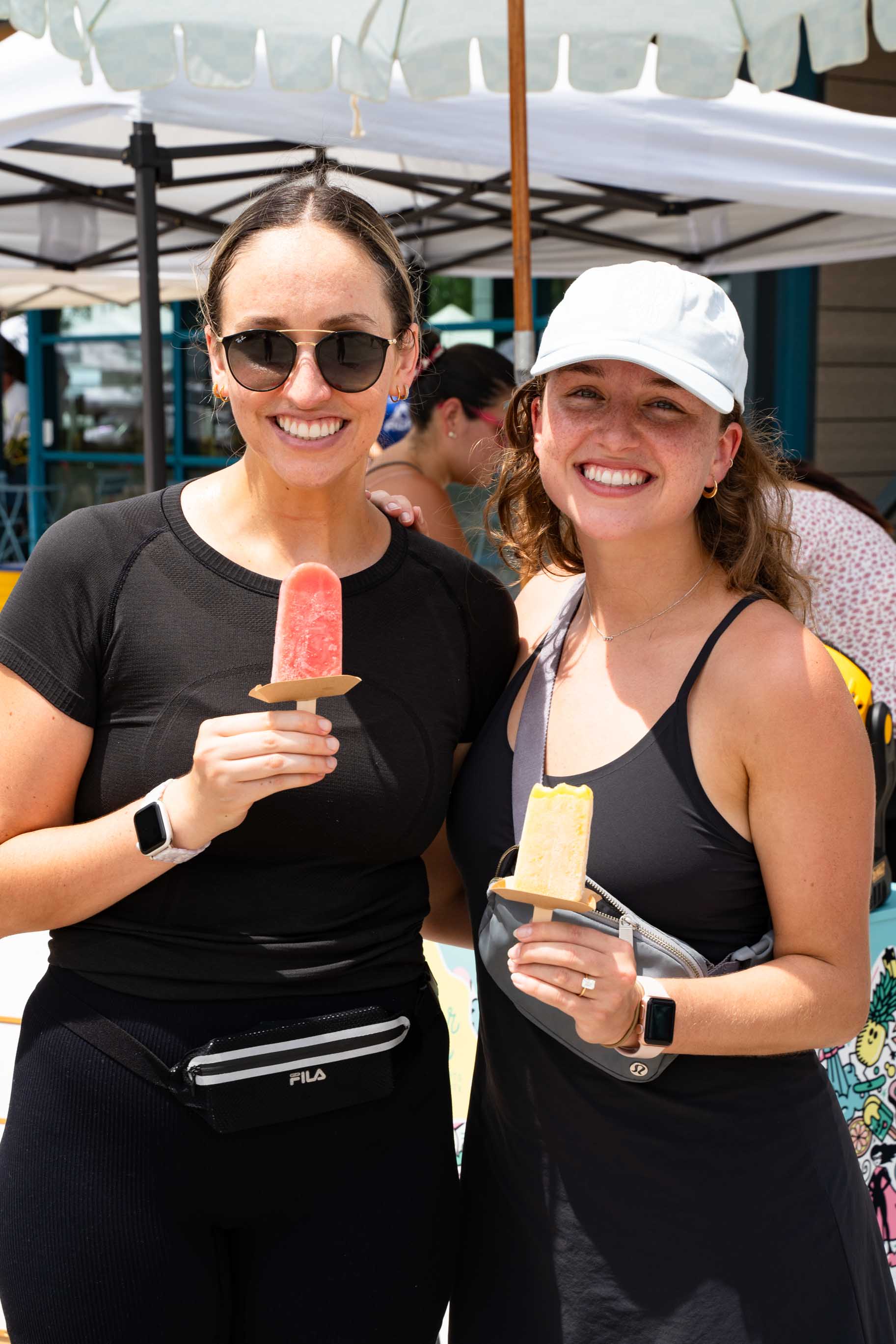 Two women enjoying local ice pops.